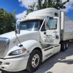 Nika Transport LLC employee conducting truck maintenance.