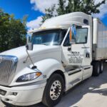 Nika Transport LLC truck providing last-mile delivery in a residential area.